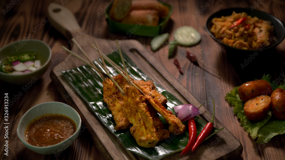 Cropped shot of Thai traditional street food with pork satay with peanut sauce and Thai appetisers