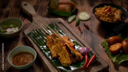 Cropped shot of Thai traditional street food with pork satay with peanut sauce and Thai appetisers