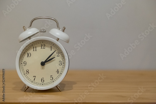 Alarm clock on the wood table beside the bed