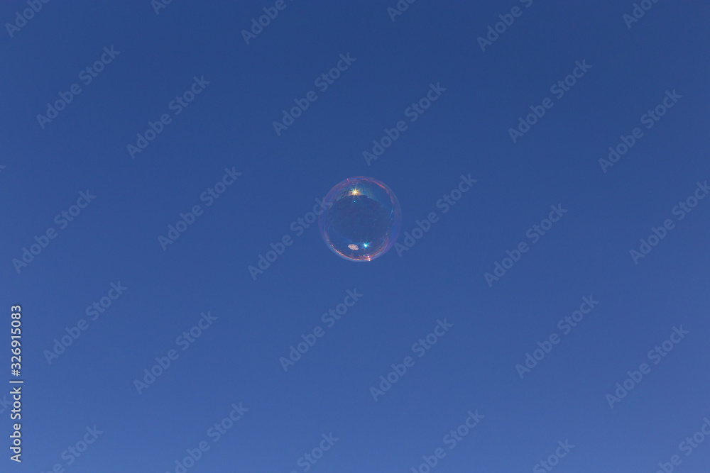 Perfect bubble floats high in the bright blue sky Perfect bubble floats high in the bright blue sky