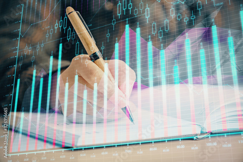 Double exposure of woman's hands making notes with forex graph hologram. Concept technical analysis.