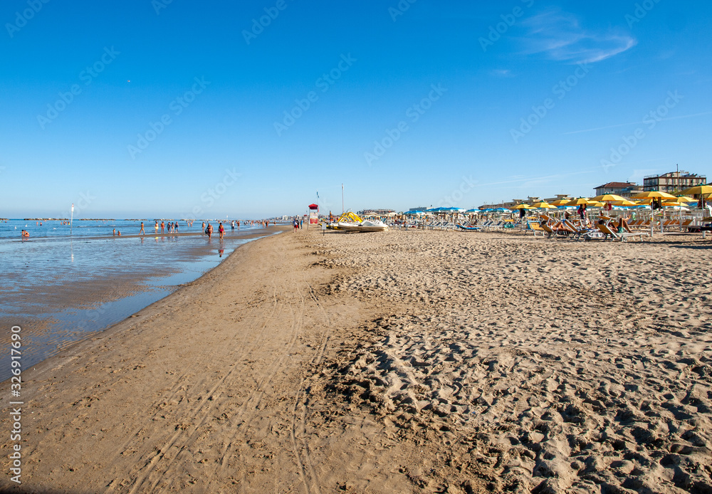 People are resting on a sunny day at the beach in Cesenatico, Italy People are resting on a sunny day at the beach in Cesenatico, Italy