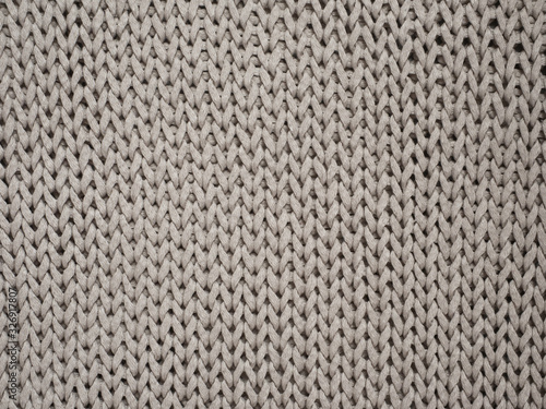 Cotton handmade knitted large blanket, trendy concept. Close-up of knitted blanket, knit background