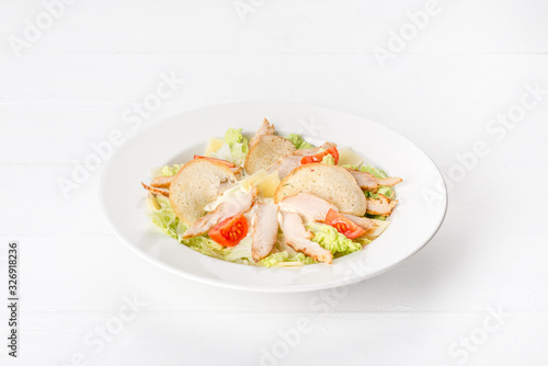 Caesar salad made from chicken meat, lettuce, tomato and cheese.
