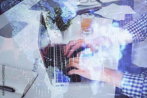 Double exposure of graph with man typing on computer in office on background. Concept of hard work.