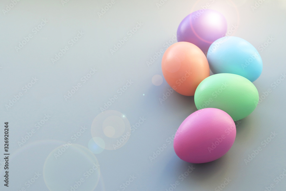 Easter colored eggs on a gray background and beautiful light highlights Selective focus. The Symbol Of Easter. Easter colored eggs on a gray background and beautiful light highlights Selective focus. The Symbol Of Easter.