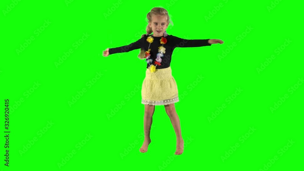 Happy young girl dancing and smiling over green background. Happy young girl dancing and smiling over green background.