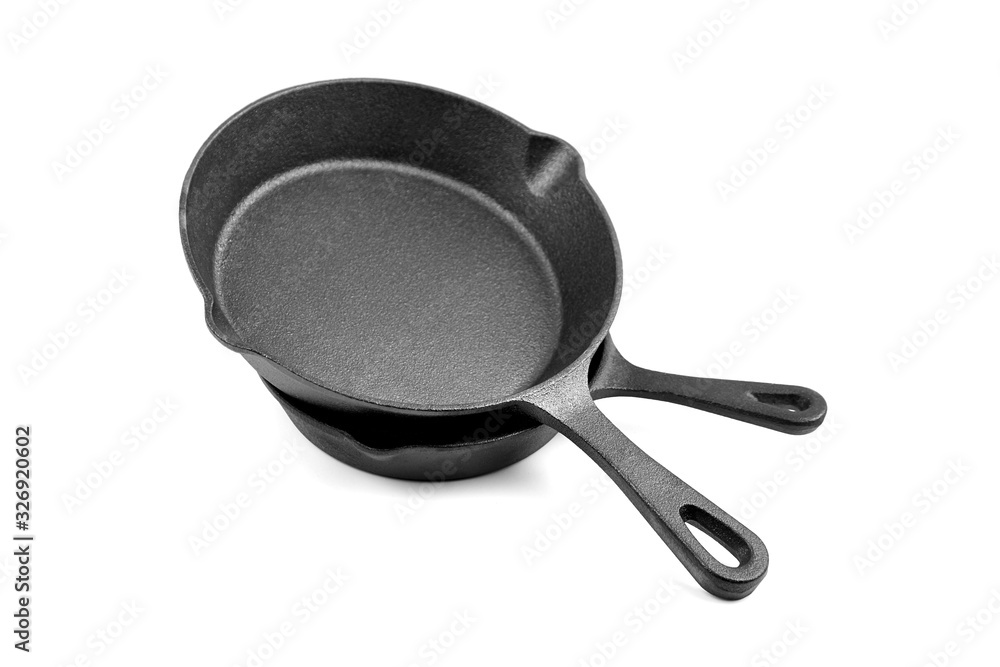 Cast iron pans isolated on white background. Two black empty skillets. Kitchen equipment, cookware Cast iron pans isolated on white background. Two black empty skillets. Kitchen equipment, cookware
