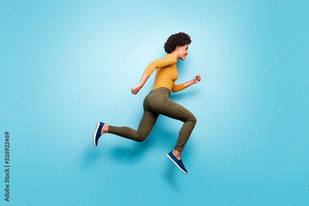 Full length body size profile side view of her she nice attractive cheery purposeful wavy-haired girl running fast isolated on bright vivid shine vibrant blue green teal turquoise color background