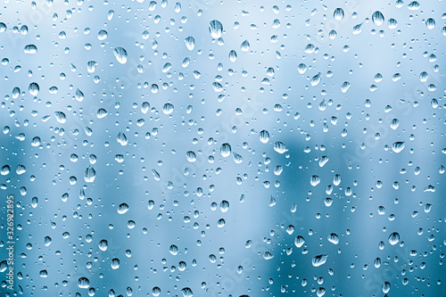 Water​ rain​ drops​ on​ glass​ background.​ Rain​ drops​ on​ a​ Windows. 