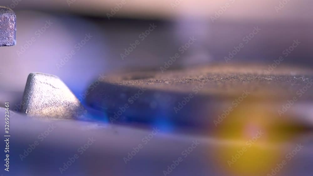 Close up of flame ignition on a gas ring on a range cooker in the kitchen Close up of flame ignition on a gas ring on a range cooker in the kitchen