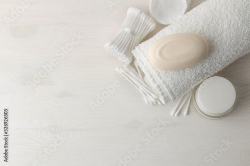 Various personal care products. Cotton pads and sticks, soap, towel on a white background. top view. place for text