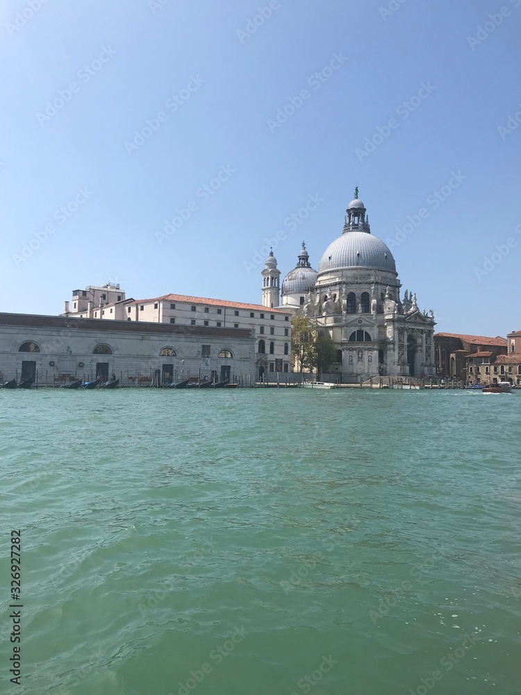 View of a traveler from the deck of a ship on the beauty of medieval architecture of the cathedrals and temples of Venice.