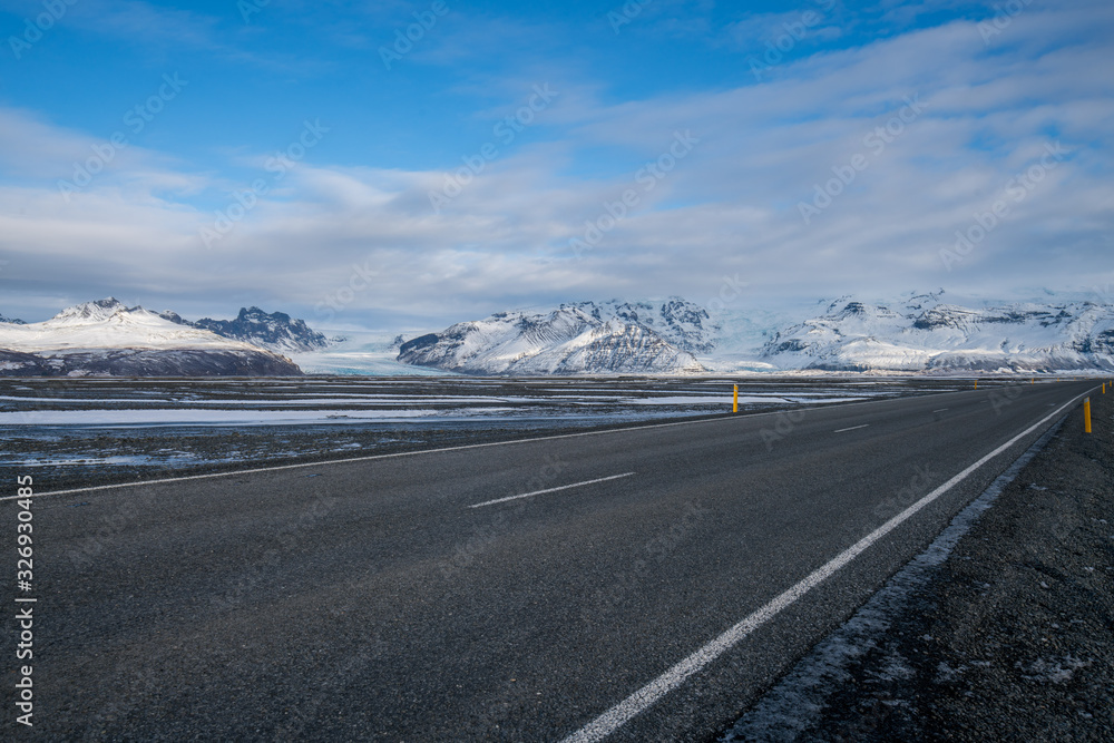 Rural curve highway road among the snow mountain in Iceland Rural curve highway road among the snow mountain in Iceland