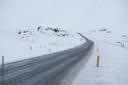 Rural curve highway road among the snow mountain in Iceland © Sen