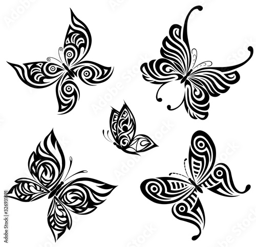 Vector background with the image set of black and white butterflies in the form of a tribal tattoo 