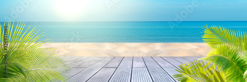 Tropical sea beach with sand  ocean  palm leaves and blue sky