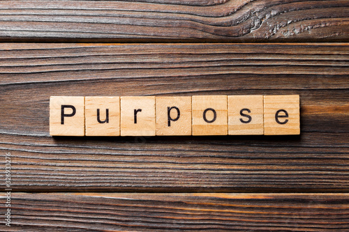 purpose word written on wood block. purpose text on table, concept