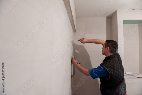 professional plumber working in a bathroom © .shock