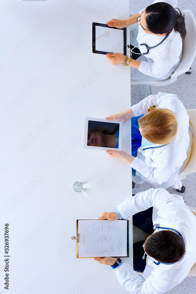 © khmelev - Group of doctors sitting in he office with gadgets and tablets in hospital , top view © khmelev - Group of doctors sitting in he office with gadgets and tablets in hospital , top view