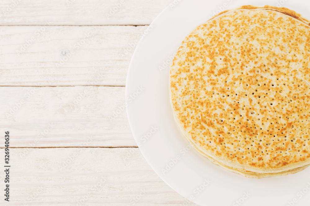 pancakes on plate on white wooden background pancakes on plate on white wooden background