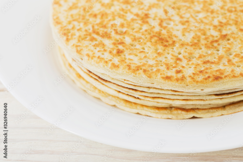 pancakes on plate on white wooden background pancakes on plate on white wooden background