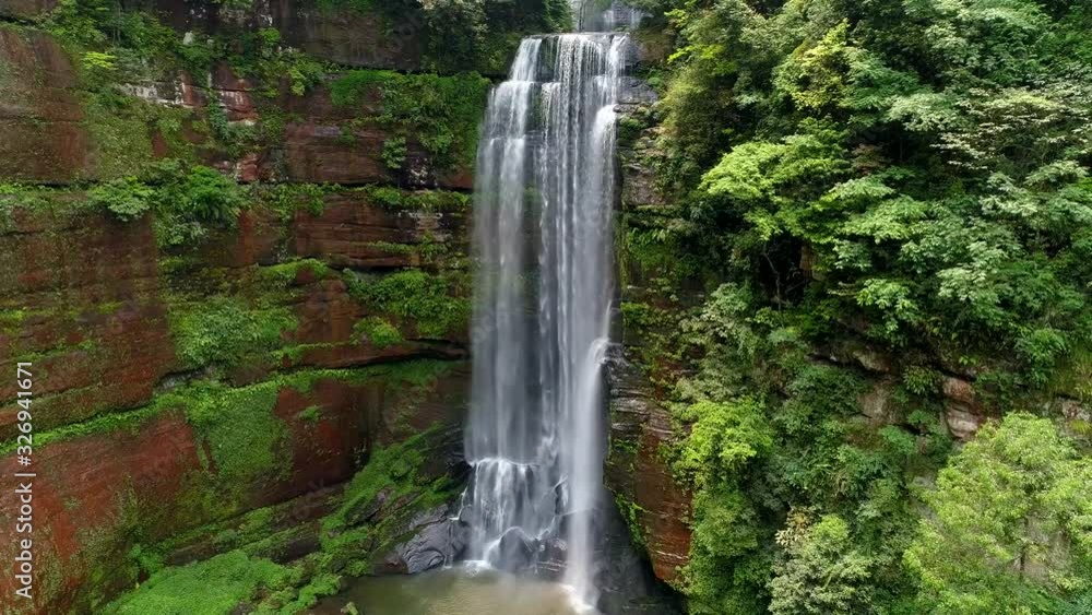 Beautiful stream and cascade in the forest; zoom out of even cliff, trees, and cascade Beautiful stream and cascade in the forest; zoom out of even cliff, trees, and cascade