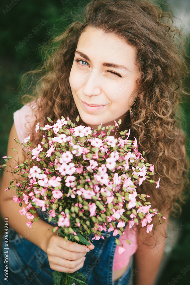 Beautiful happy woman with pink flowers bouquet smile in summer Beautiful happy woman with pink flowers bouquet smile in summer