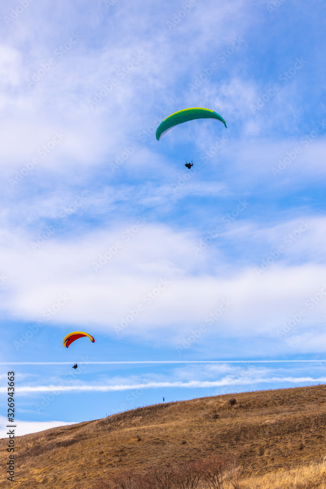 Skydiver On Colorful Parachute In Sky. Active Hobbies Skydiver On Colorful Parachute In Sky. Active Hobbies