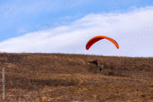 Skydiver On Colorful Parachute In Sky. Active Hobbies