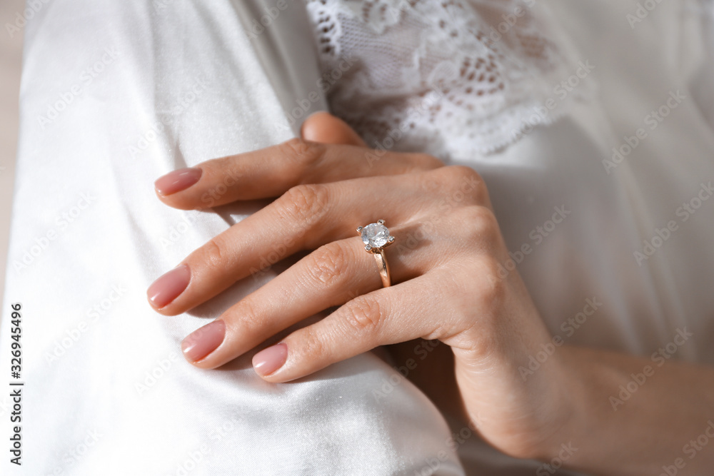 Young woman wearing beautiful engagement ring, closeup Young woman wearing beautiful engagement ring, closeup
