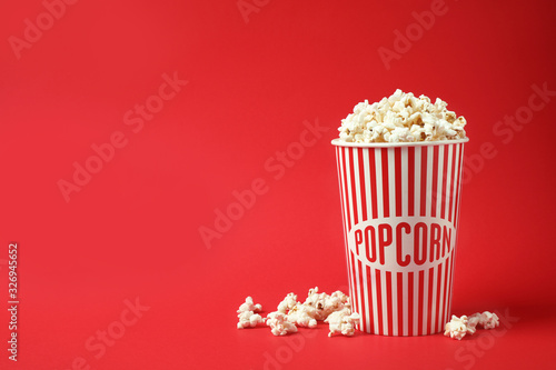 Delicious popcorn on red background. Space for text