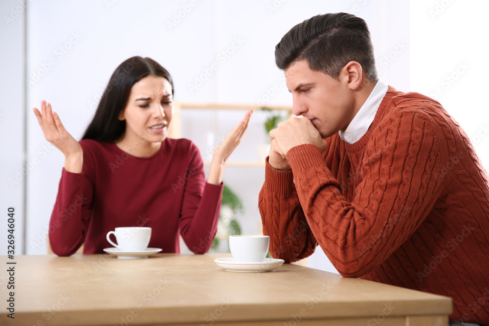 Couple having quarrel in cafe. Relationship problems