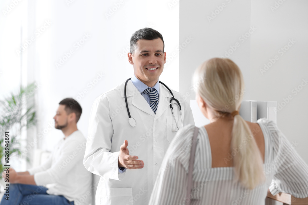 Doctor talking with patient in hospital hall Doctor talking with patient in hospital hall