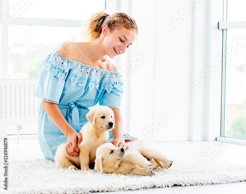 Nice girl and retriever puppies