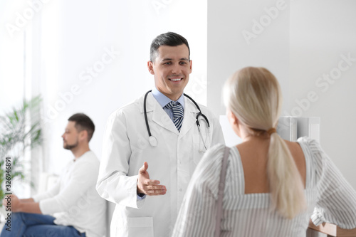 Doctor talking with patient in hospital hall