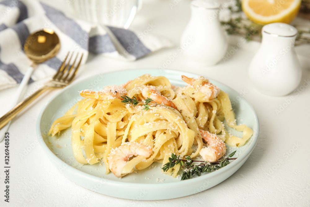 Delicious pasta with shrimps on white table