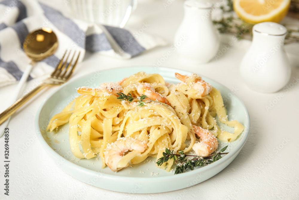 Delicious pasta with shrimps on white table Delicious pasta with shrimps on white table