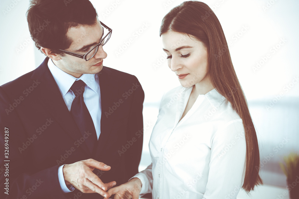 Businessmen and woman using tablet computer in modern office. Colleagues or company managers at workplace. Partners discussing contract. Business concept Businessmen and woman using tablet computer in modern office. Colleagues or company managers at workplace. Partners discussing contract. Business concept