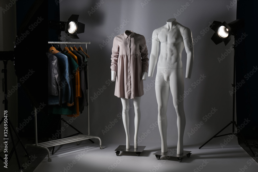 Ghost mannequins, clothes and professional lighting equipment in modern photo studio Ghost mannequins, clothes and professional lighting equipment in modern photo studio
