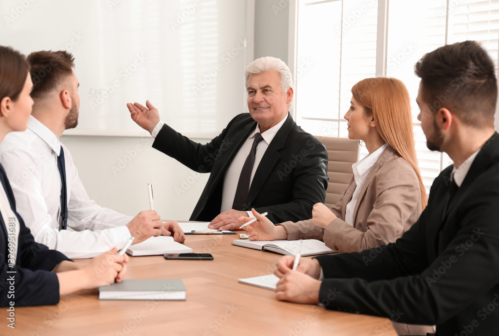 Senior business trainer working with people in office Senior business trainer working with people in office