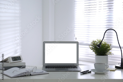 Modern laptop on office table. Stylish workplace © New Africa