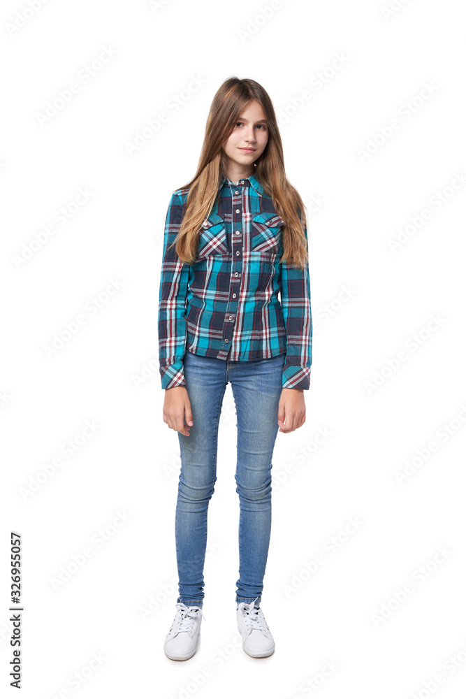 Teen girl in checkered shirt standing casually