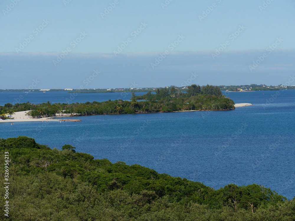 Beautiful island of Harvest Caye, Belize, surrounded by the blue waters of the Caribbean Sea.