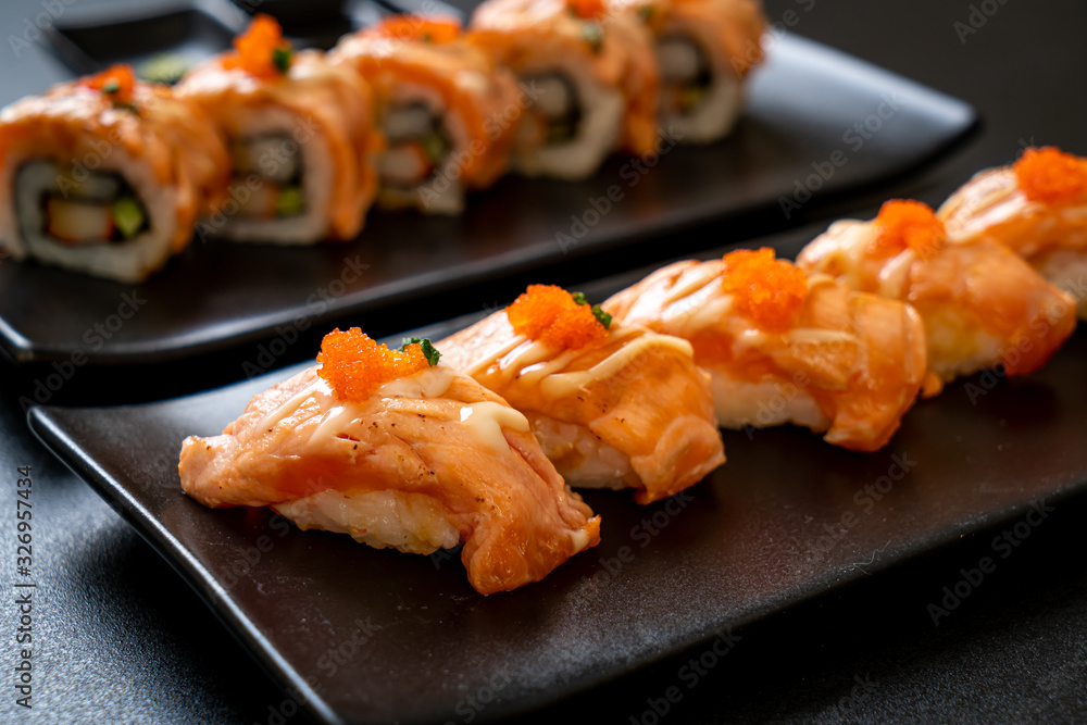 grilled salmon sushi on black plate grilled salmon sushi on black plate