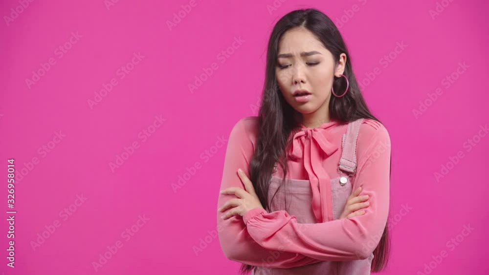 upset kazakh girl standing with crossed arms isolated on pink upset kazakh girl standing with crossed arms isolated on pink