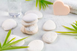Cosmetic and Beauty spa relaxing concept. White natural zen stones scene on white marble. wellness natural therapy.