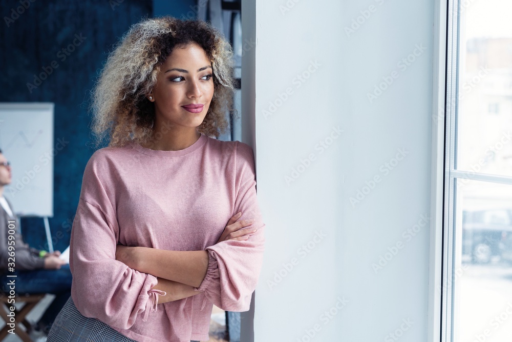 Fototapeta premium Modern young African business woman in the office with copy space.