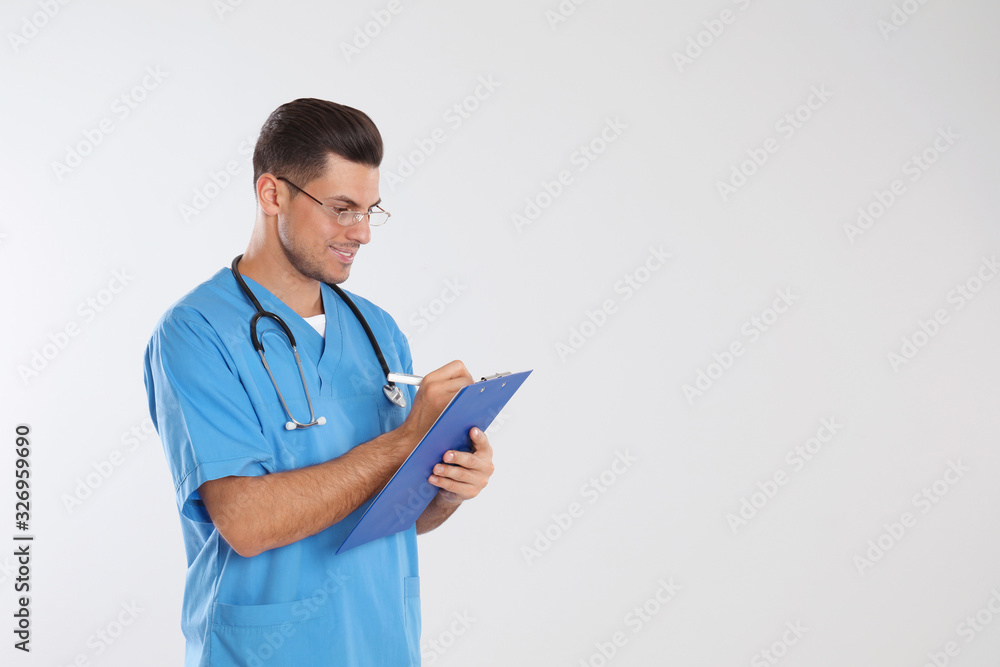 Doctor with stethoscope and clipboard on light grey background. Space for text Doctor with stethoscope and clipboard on light grey background. Space for text