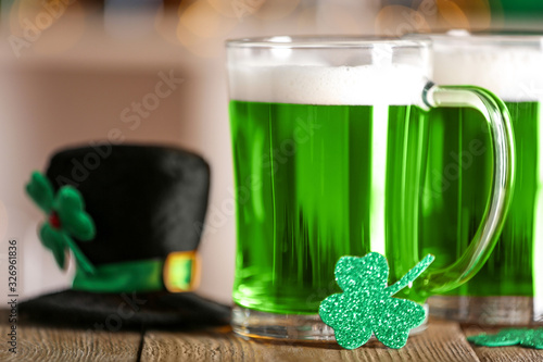 Green beer and clover on wooden counter, closeup. St.Patrick's Day